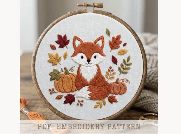 Fall embroidery patterns featuring a fox surrounded by autumn leaves and pumpkins in an embroidery hoop