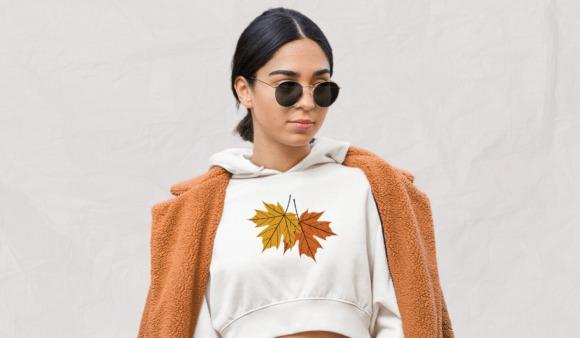 fall leaf embroidery of two maple leaves in yellow and orange on white hoodie