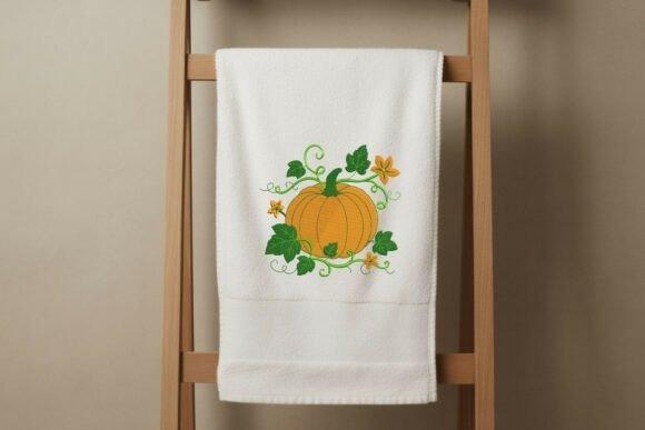 Fall embroidery designs showing an autumn pumpkin with leaves and blossoms on white towel