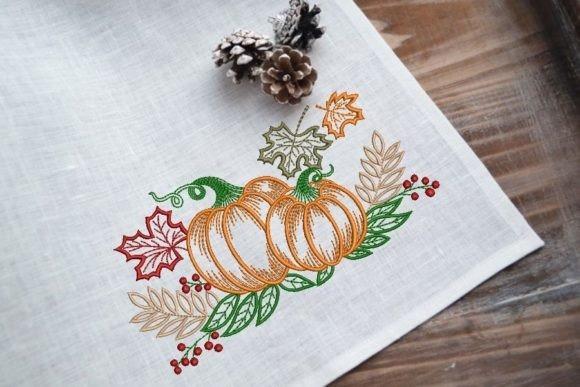 Pumpkin embroidery designs featuring two orange pumpkins with green leaves and autumn foliage on white fabric