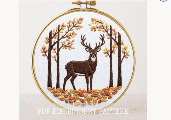 Fall embroidery patterns showing a woodland scene with a deer surrounded by trees and autumn leaves in an embroidery hoop