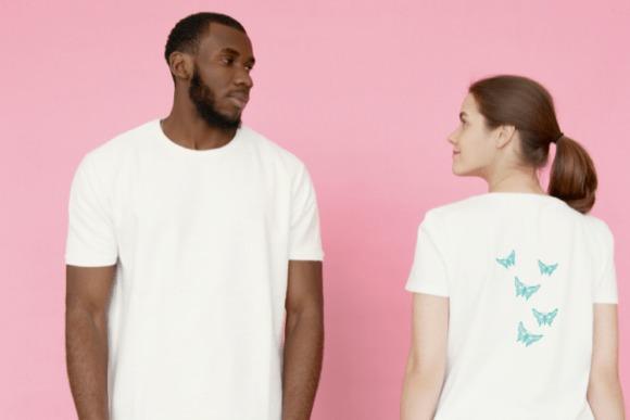 Woman wearing white t-shirt with blue butterfly embroidery design on back, man in plain white t-shirt beside her