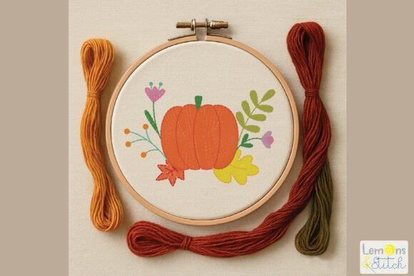 Fall embroidery patterns featuring a hand-stitched pumpkin with leaves, fern fronds, and flowers in an embroidery hoop