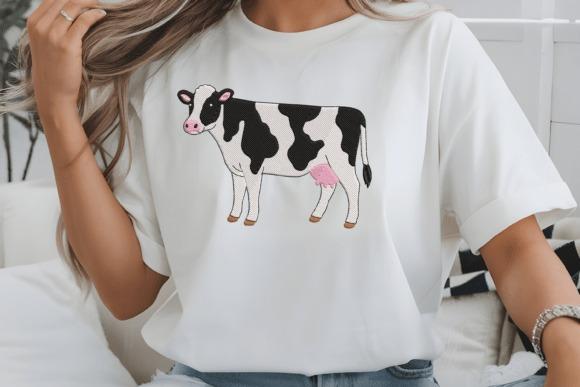 White t-shirt with black-and-white dairy cow embroidery featuring soft pink details — animal embroidery