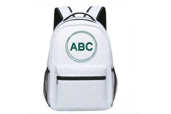 White backpack with a circular monogram embroidery featuring the letters ABC in green thread