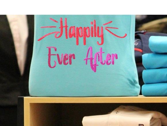 Blue fabric item with embroidered wedding gift phrase Happily Ever After in decorative red and pink lettering