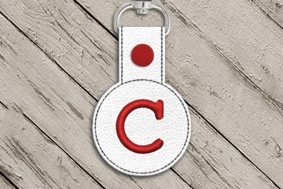 Round key fob with red letter C applique on white textured material for 4x4 machine embroidery projects