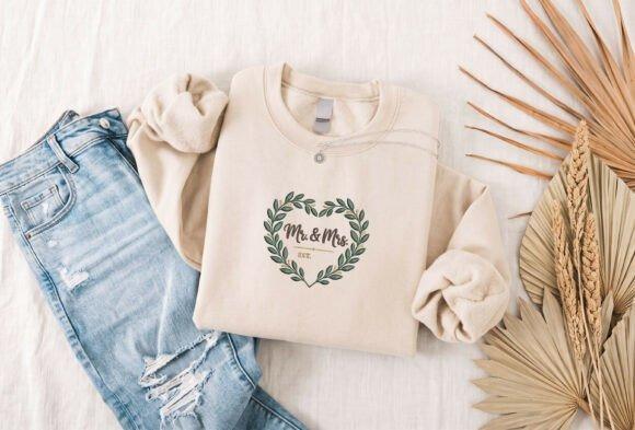Cream sweatshirt with embroidered Mr & Mrs EST wedding gift design inside leafy heart wreath — embroidered wedding gift
