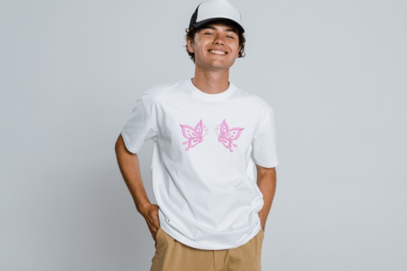 Young man wearing white t-shirt with pink butterfly embroidery — Etsy embroidery files for machine embroidery projects