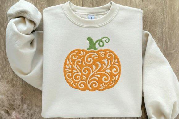 Cream sweatshirt with an orange pumpkin embroidery design featuring swirling floral and vine — fall embroidery designs