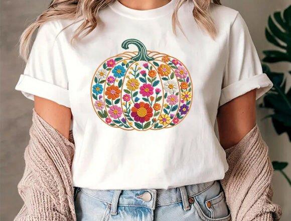 White t-shirt with a colorful pumpkin embroidery design featuring multicolored floral patterns — pumpkin embroidery designs