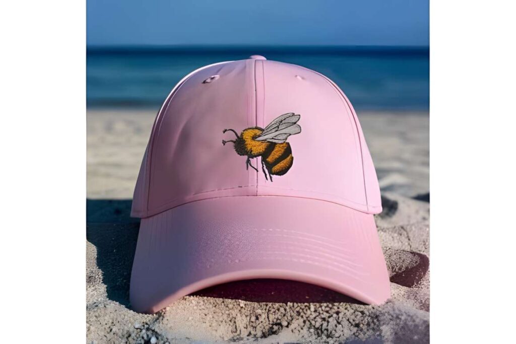 Pink cap with a bee embroidery design representing machine embroidery designs for various styles