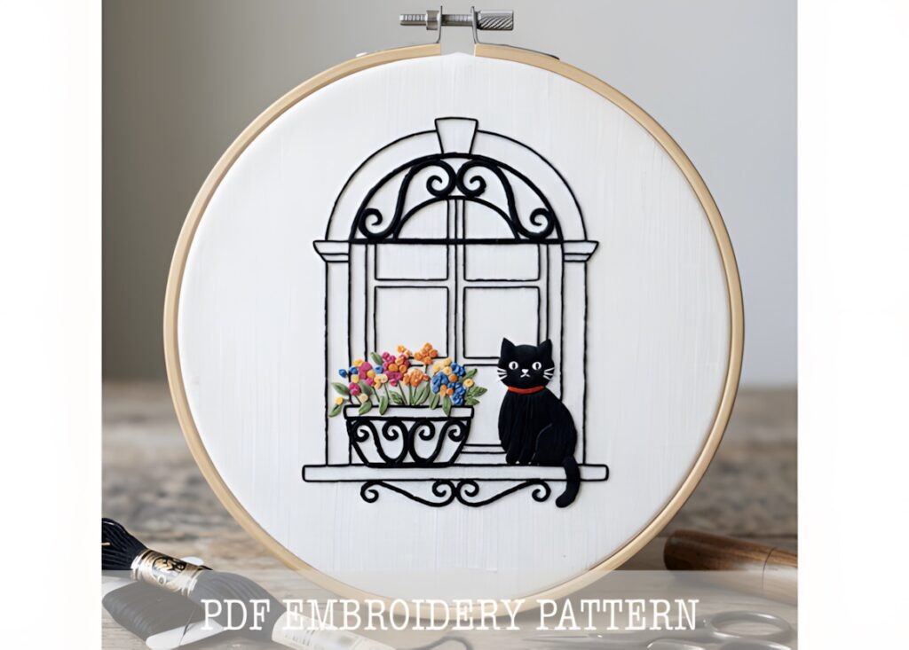 Hand embroidery patterns showing a cat sitting in a flower window with colorful flowers and decorative black window frame