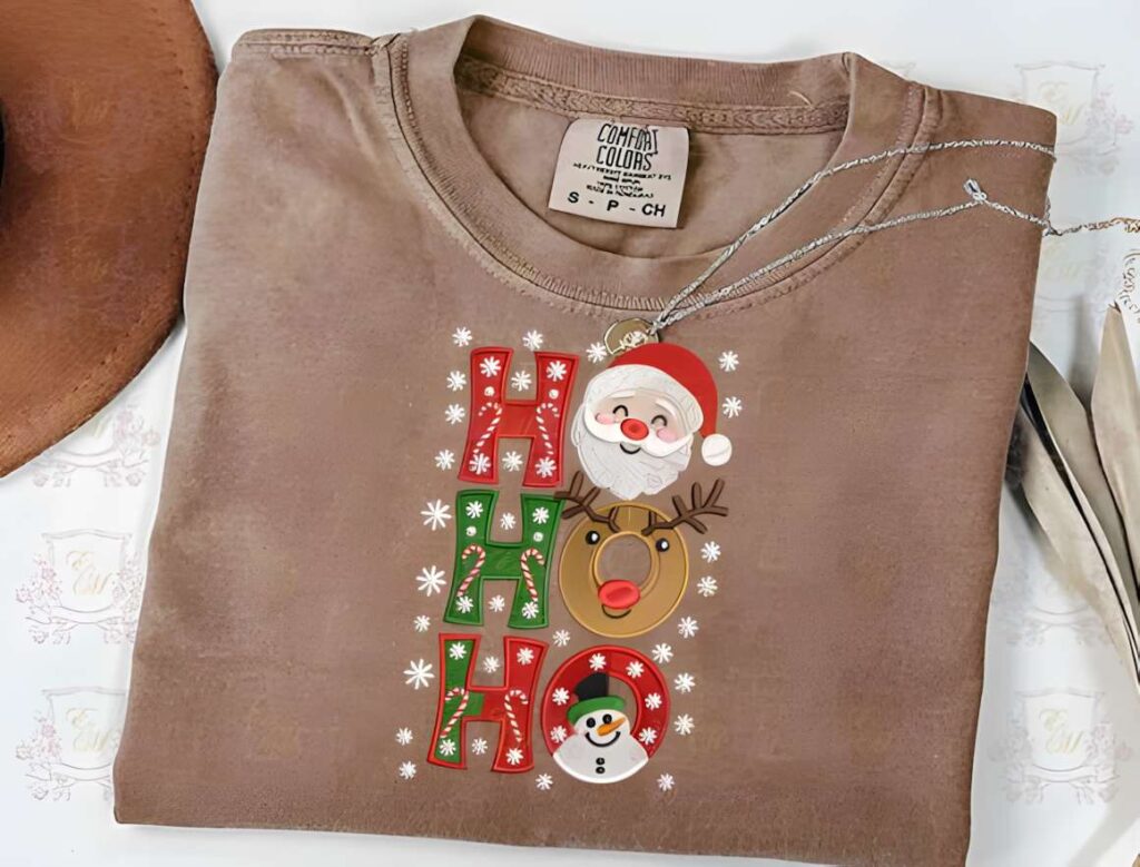Machine embroidery designs for various styles featuring Santa, reindeer, and snowman with HO HO HO text on brown shirt