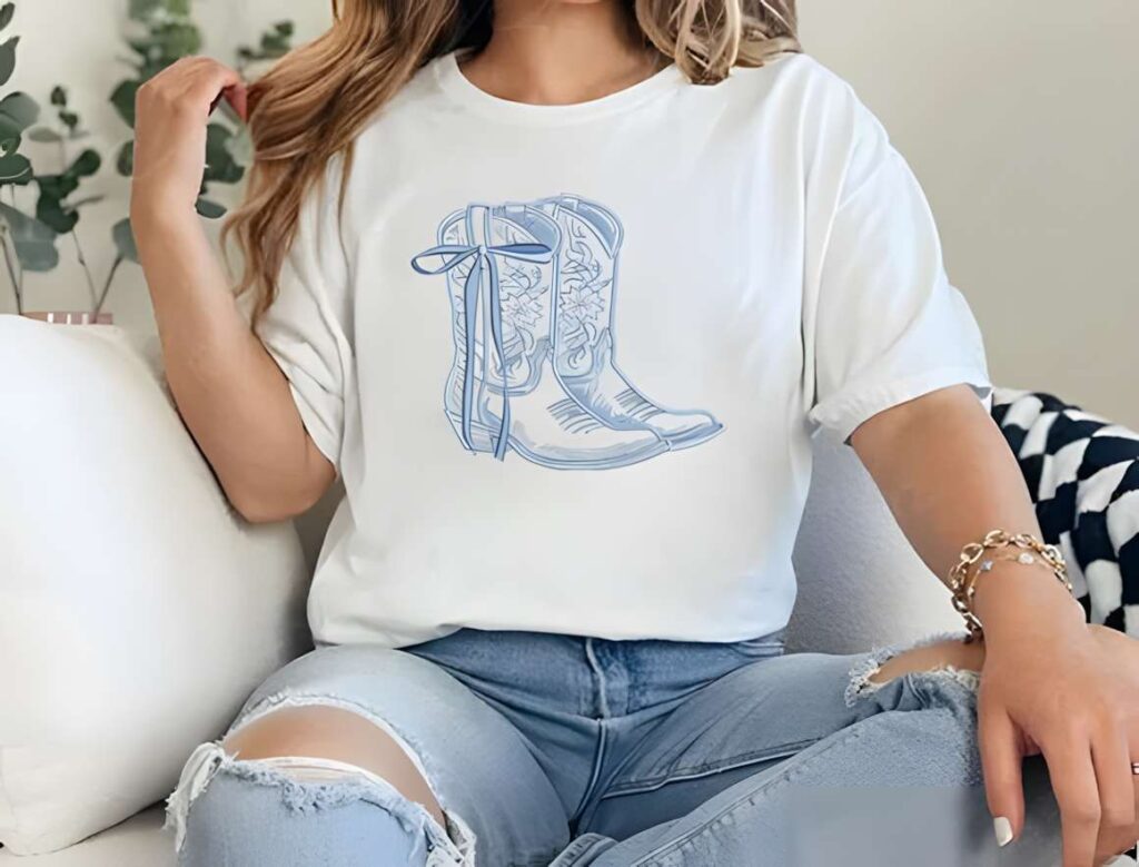White t-shirt with blue machine embroidery designs for various styles featuring cowboy boots with floral detailing